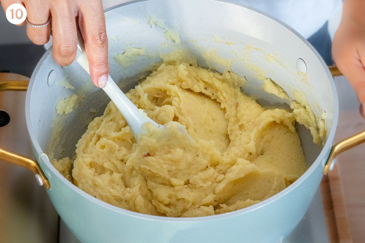 Potatoes being mixed with a spatula