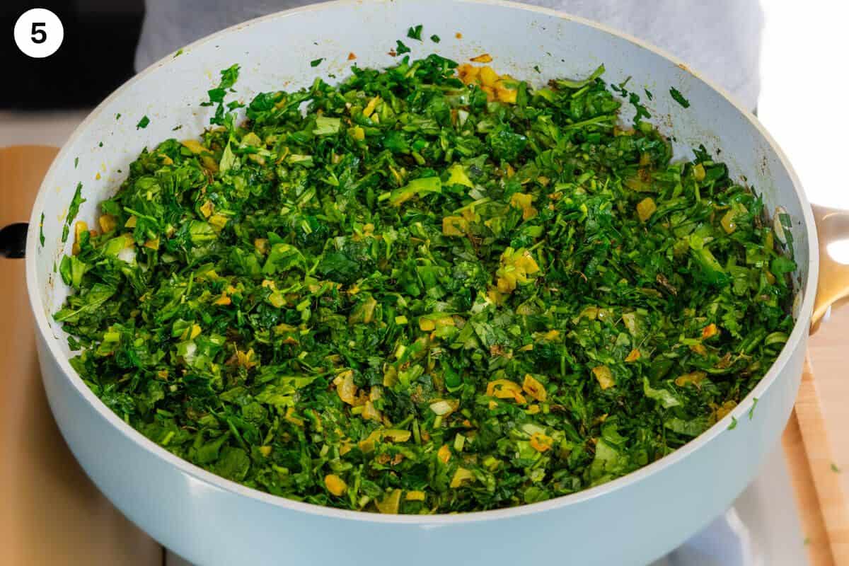 Herbs and greens added to the pan