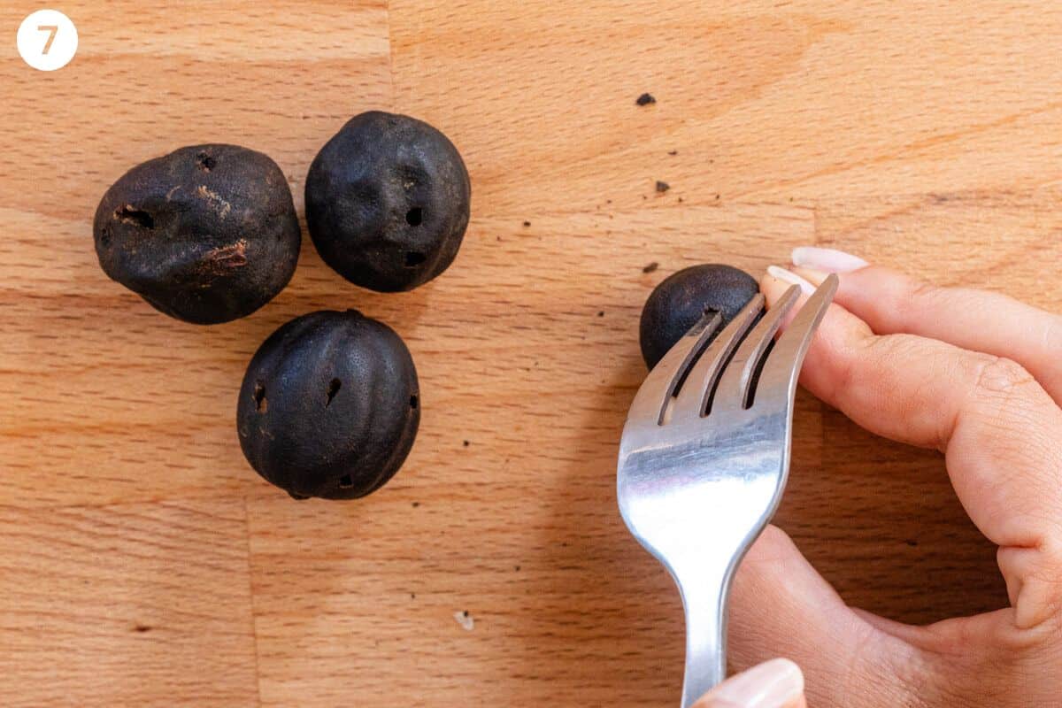 Holes being made in the dried limes with a fork