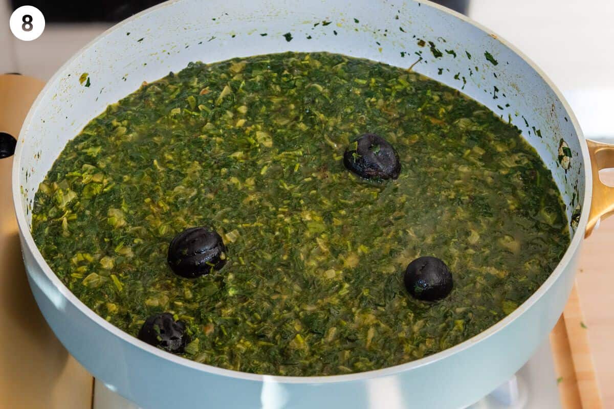 Dried limes and stock added to the pan