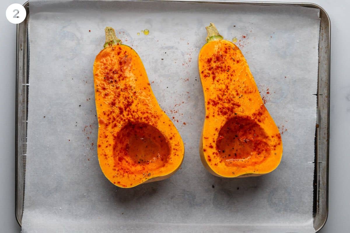 Butternut squash pieces with oil and spices added