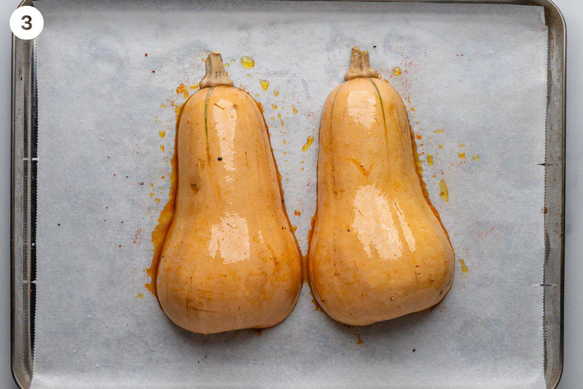 Butternut squash pieces turned face down on an oven tray