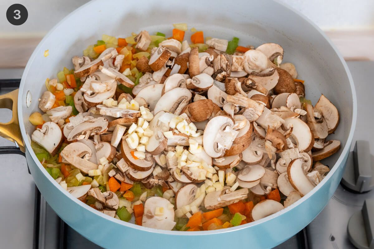 Mushrooms and garlic added to pan