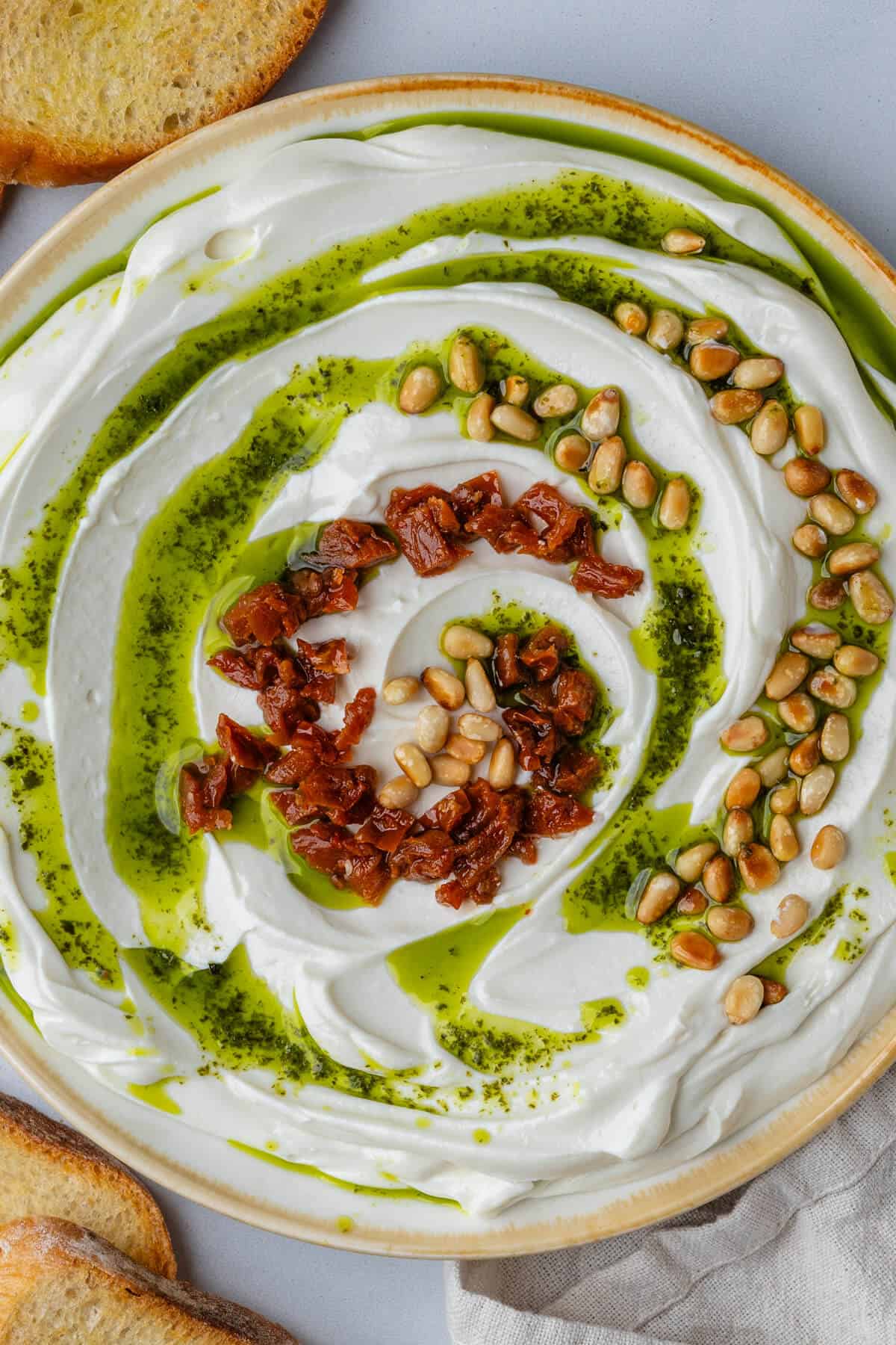 Whipped ricotta served with basil oil, pine nuts and sun dried tomatoes