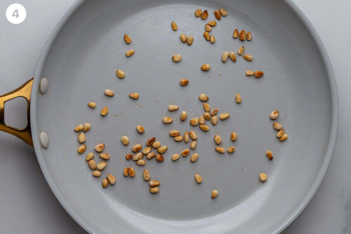 Pine nuts toasted in a pan