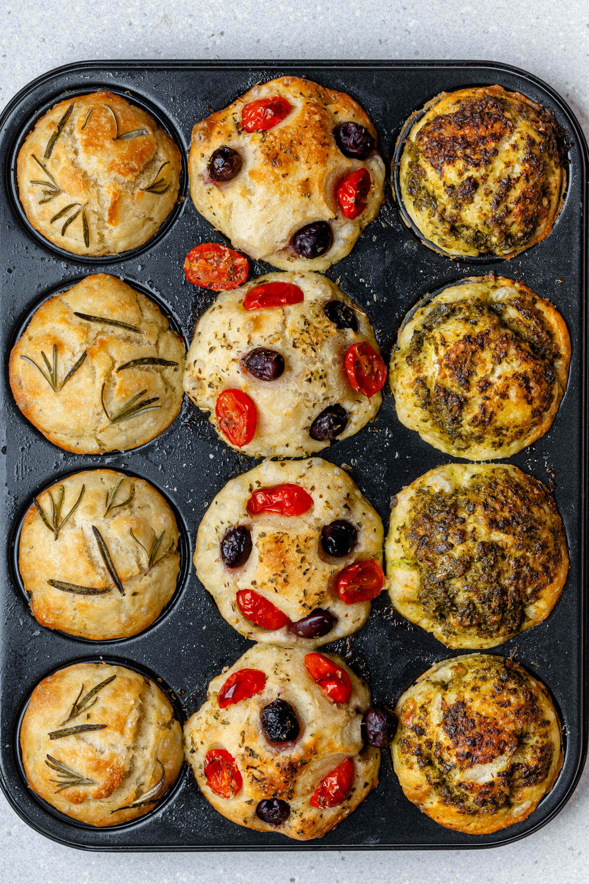 Focaccia muffins in a muffin tin straight out of the oven