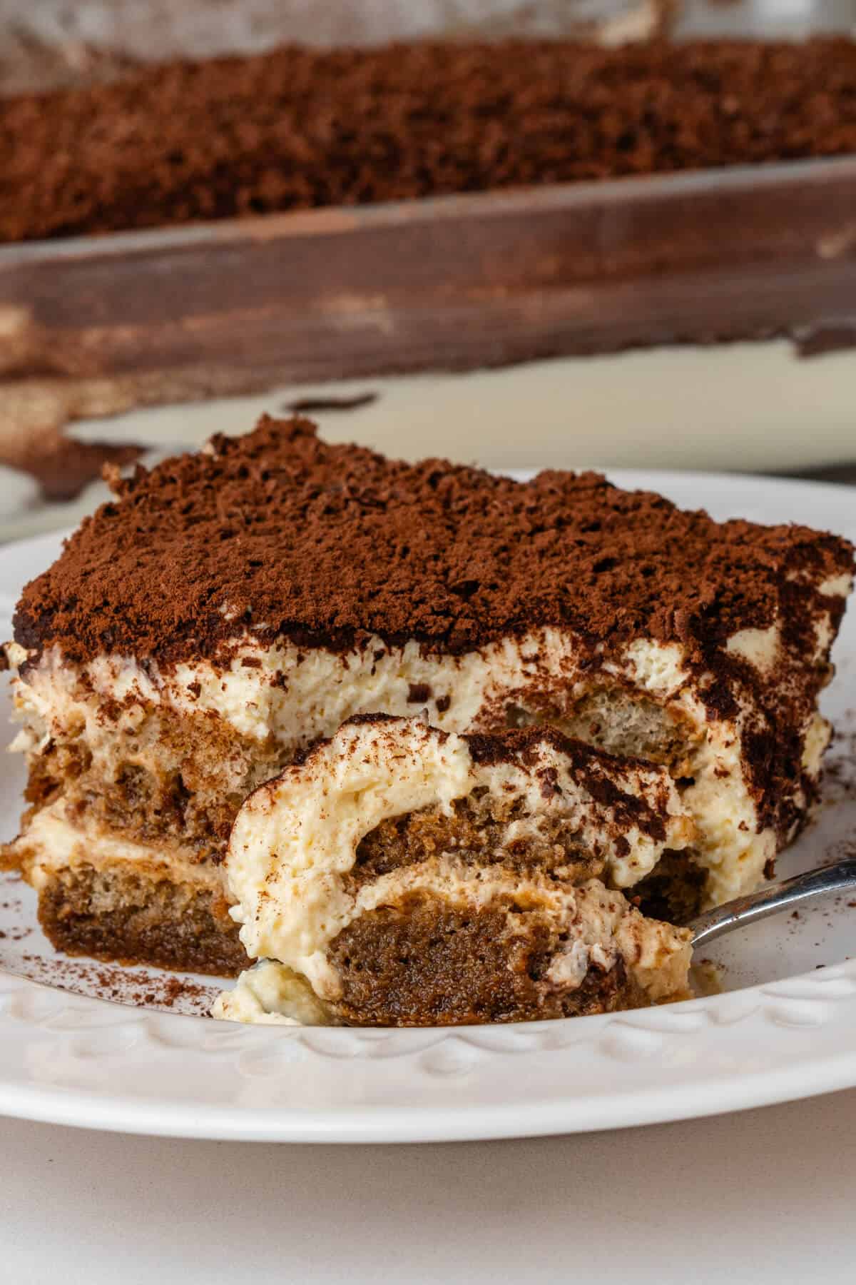 Spoon on a plate with tiramisu