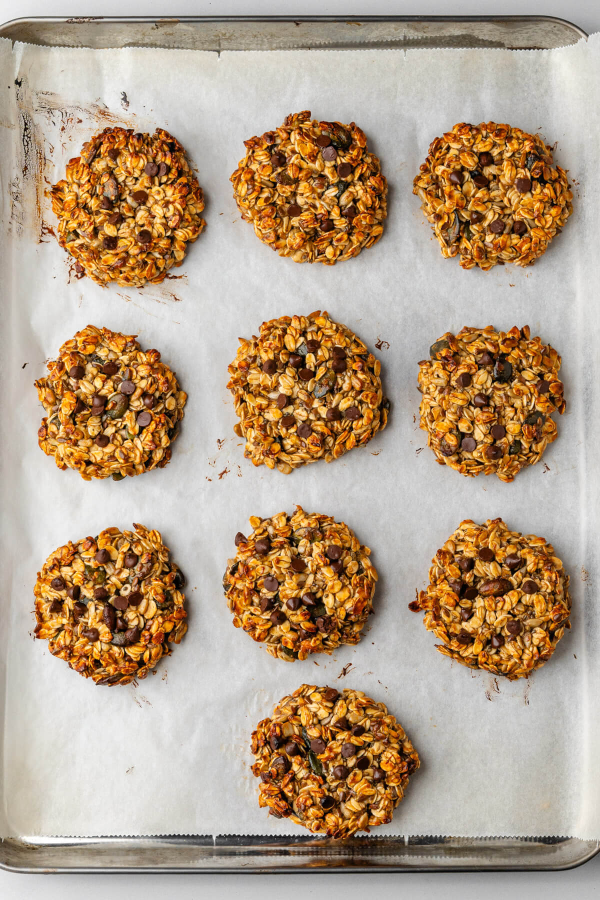 Cookies resting on a baking tray after being baked