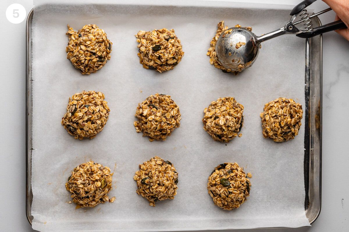 Cookies being scooped onto a baking tray