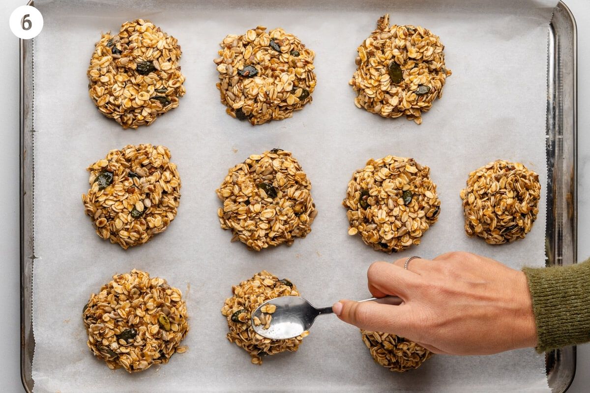 Spoon flattening each cookie down