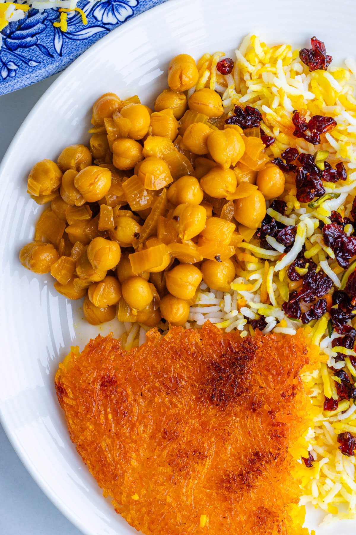 Stew served with crispy tahdig and zereshk polo