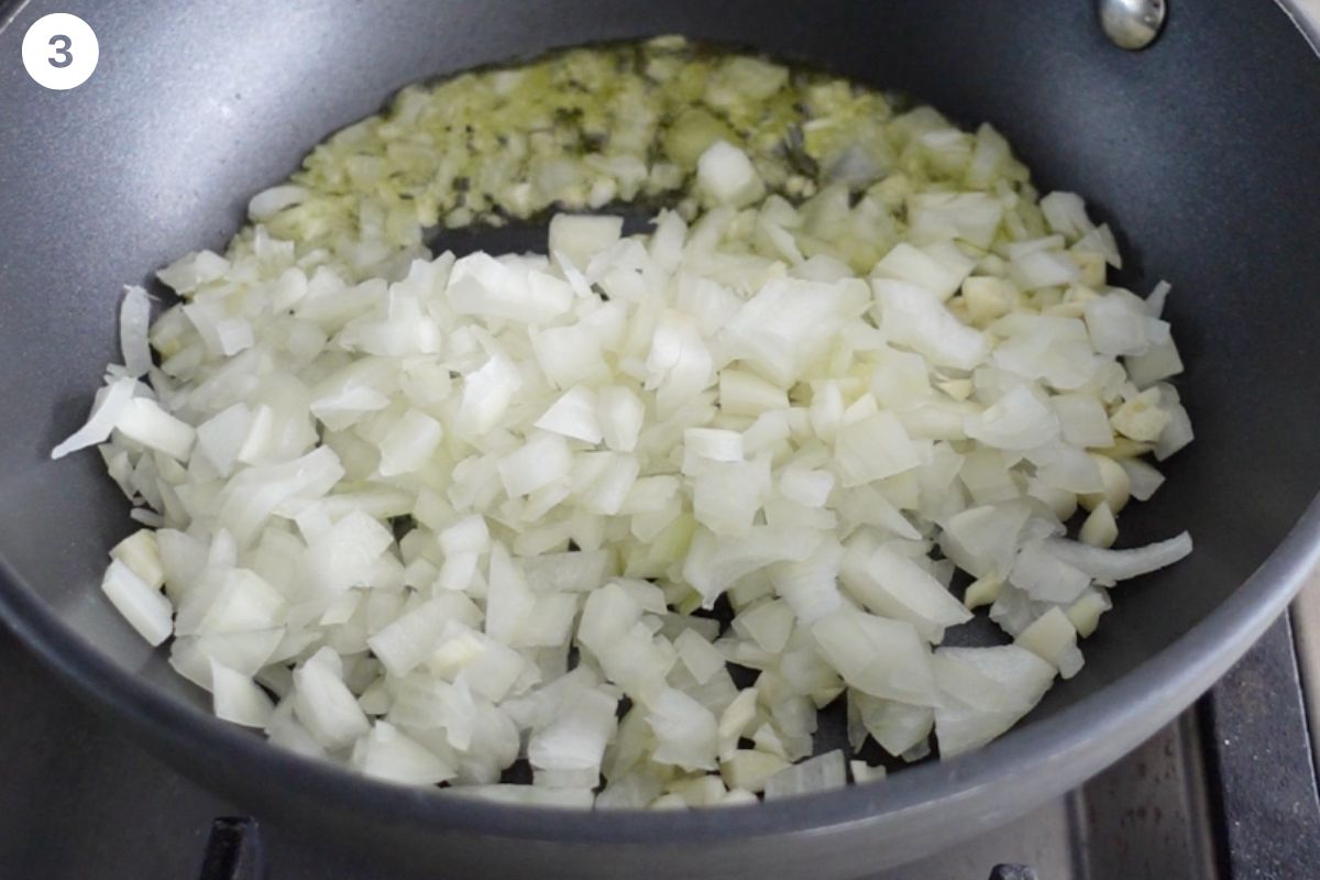 Onion and garlic being sautéed in a pan