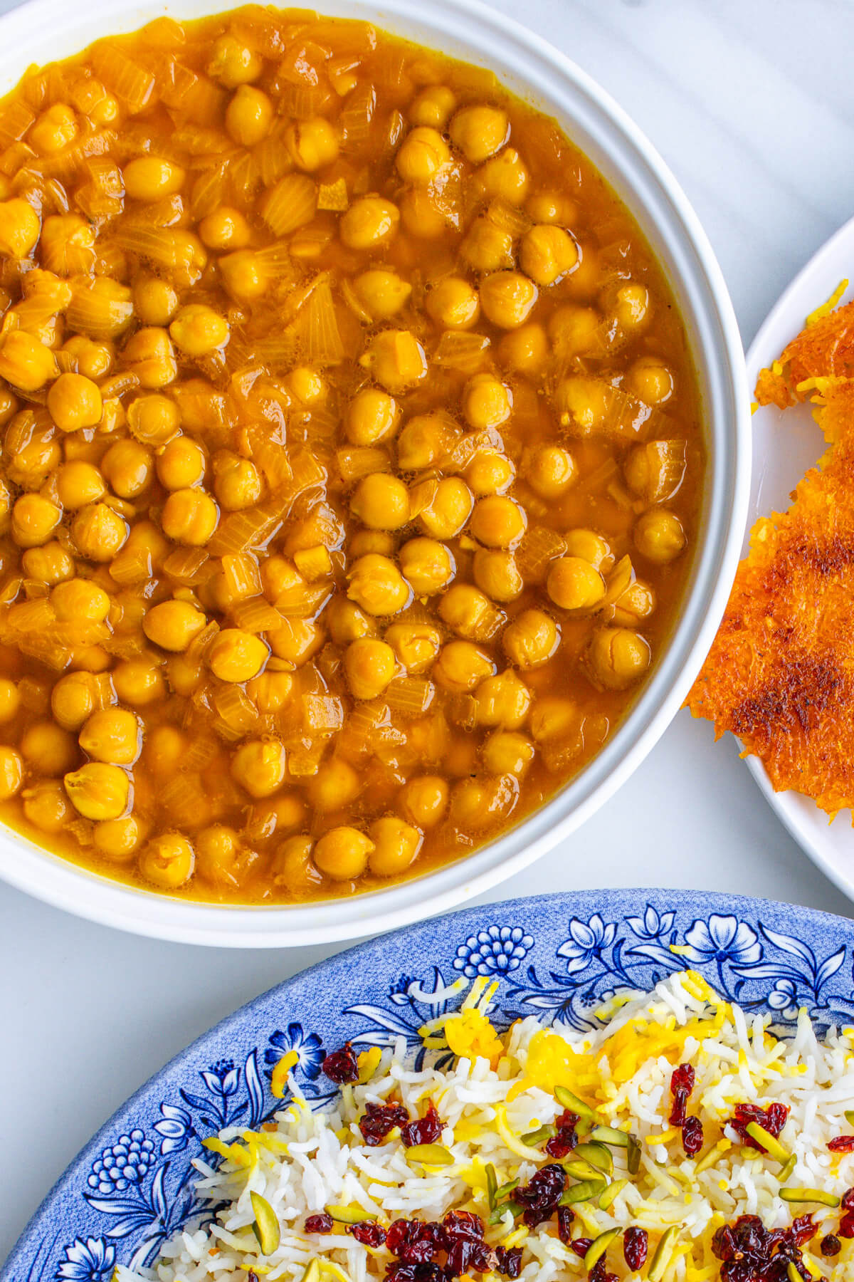 Chickpea stew in a large bowl with rice and tahdig