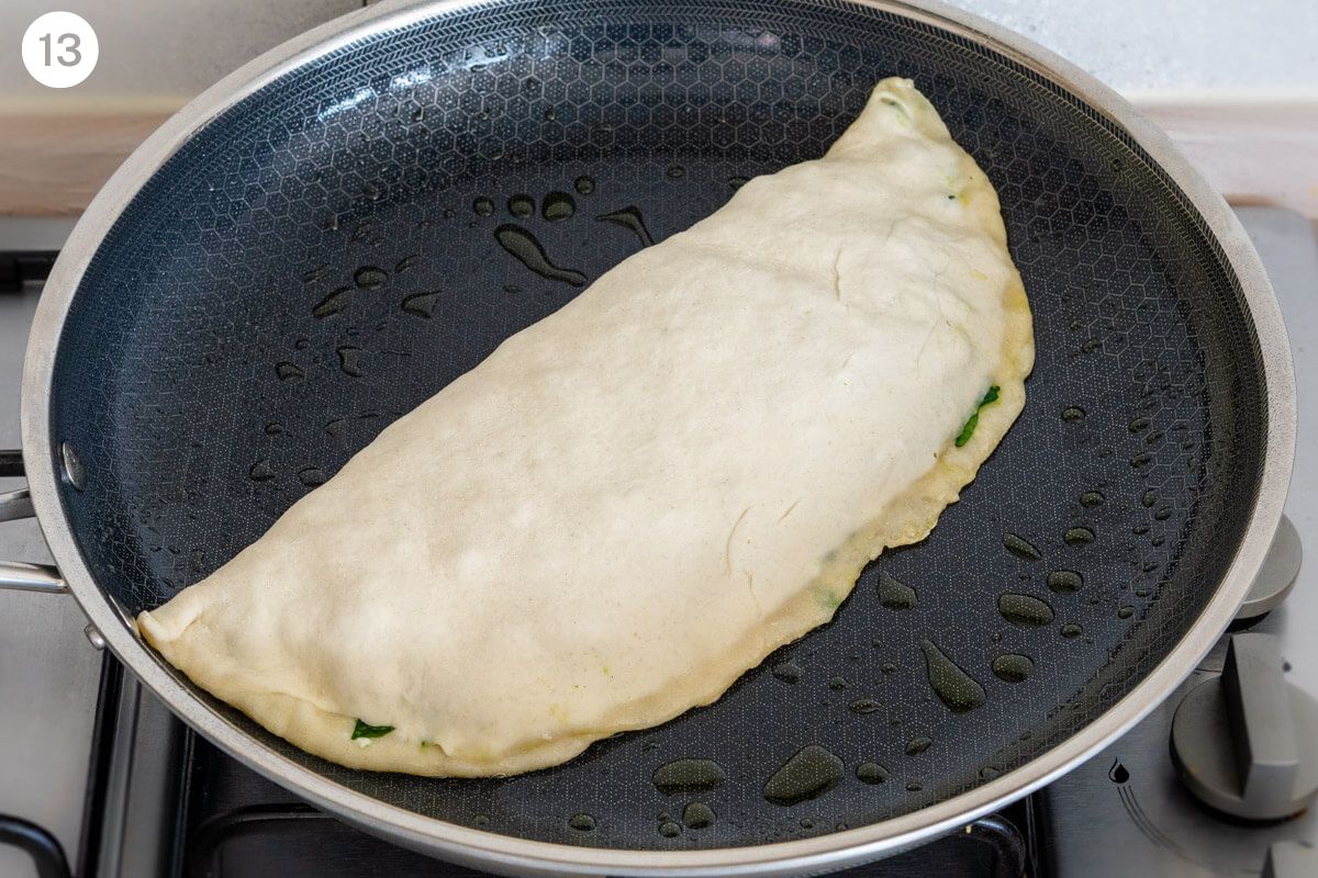 Dough being cooked on a pan until golden