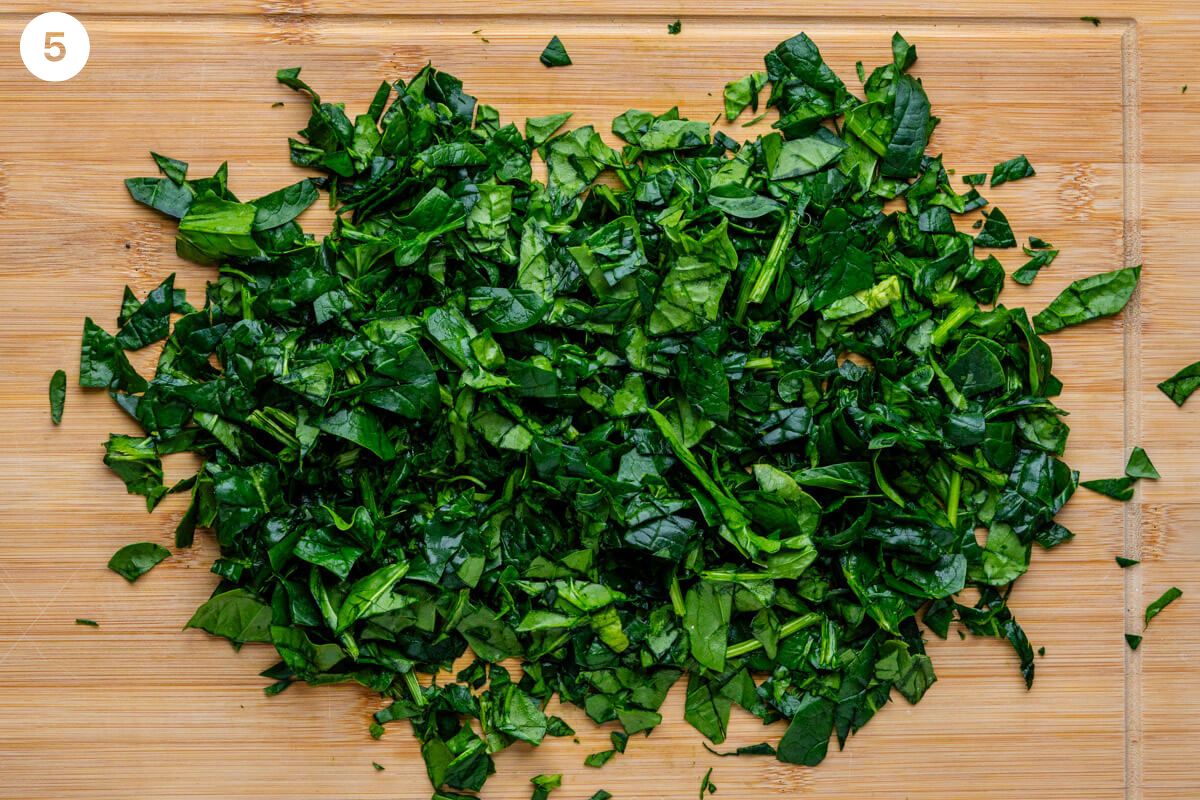 Spinach finely chopped on a cutting board