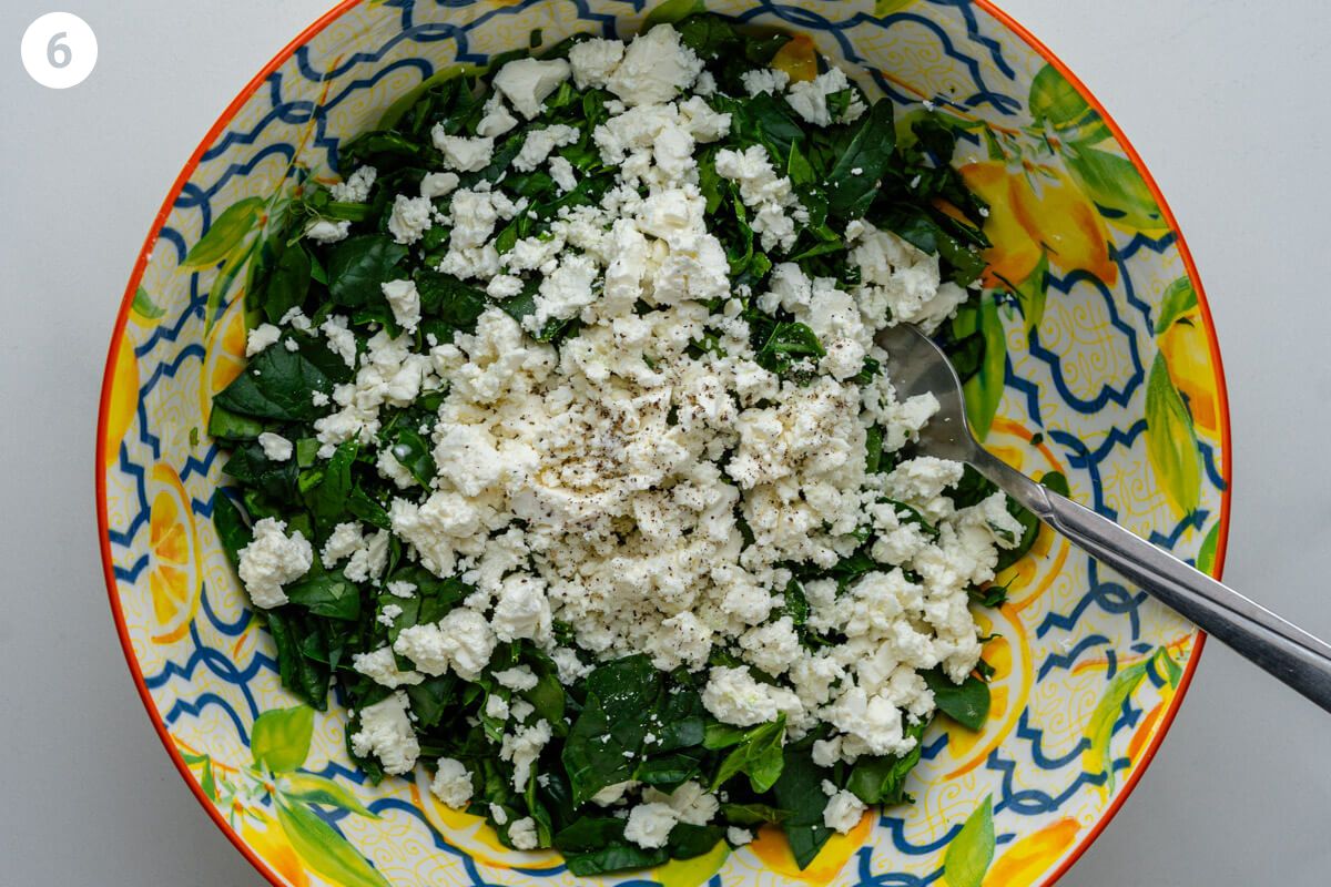 Feta and spinach in a large bowl