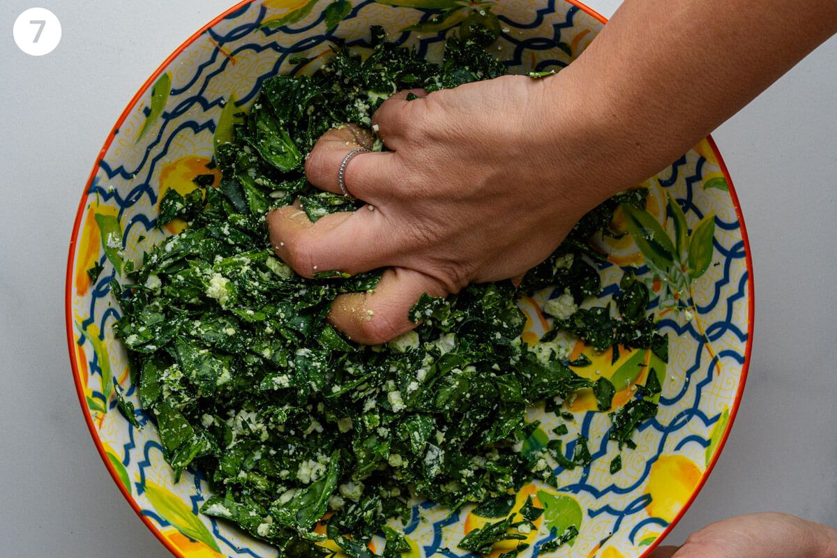 Hand mixing the spinach and feta together