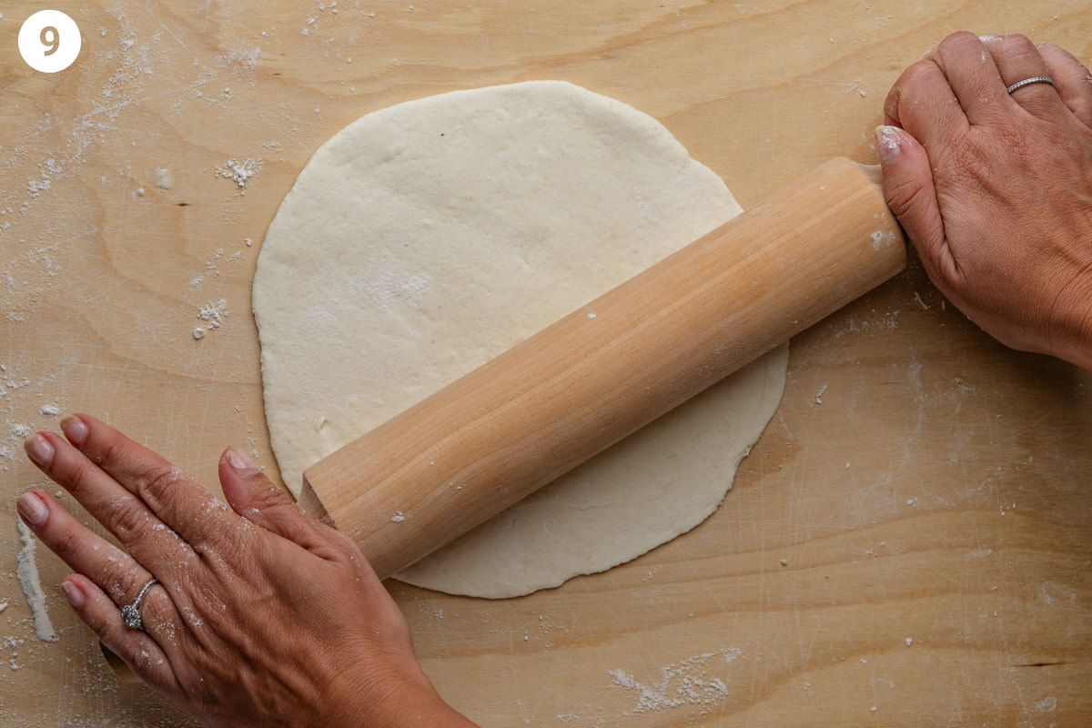 Dough being rolled with a rolling pin