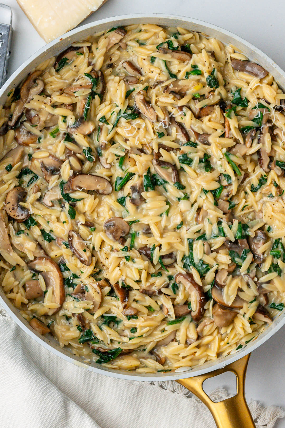 One pan mushroom orzo with topped with parmesan cheese