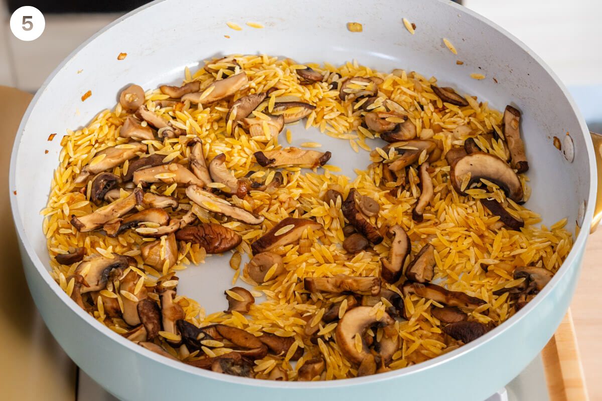 Orzo pasta added to mushrooms and onions