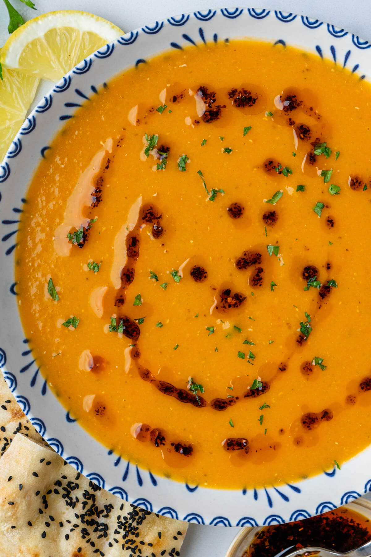 Bowl of lentil soup topped with aleppo pepper oil