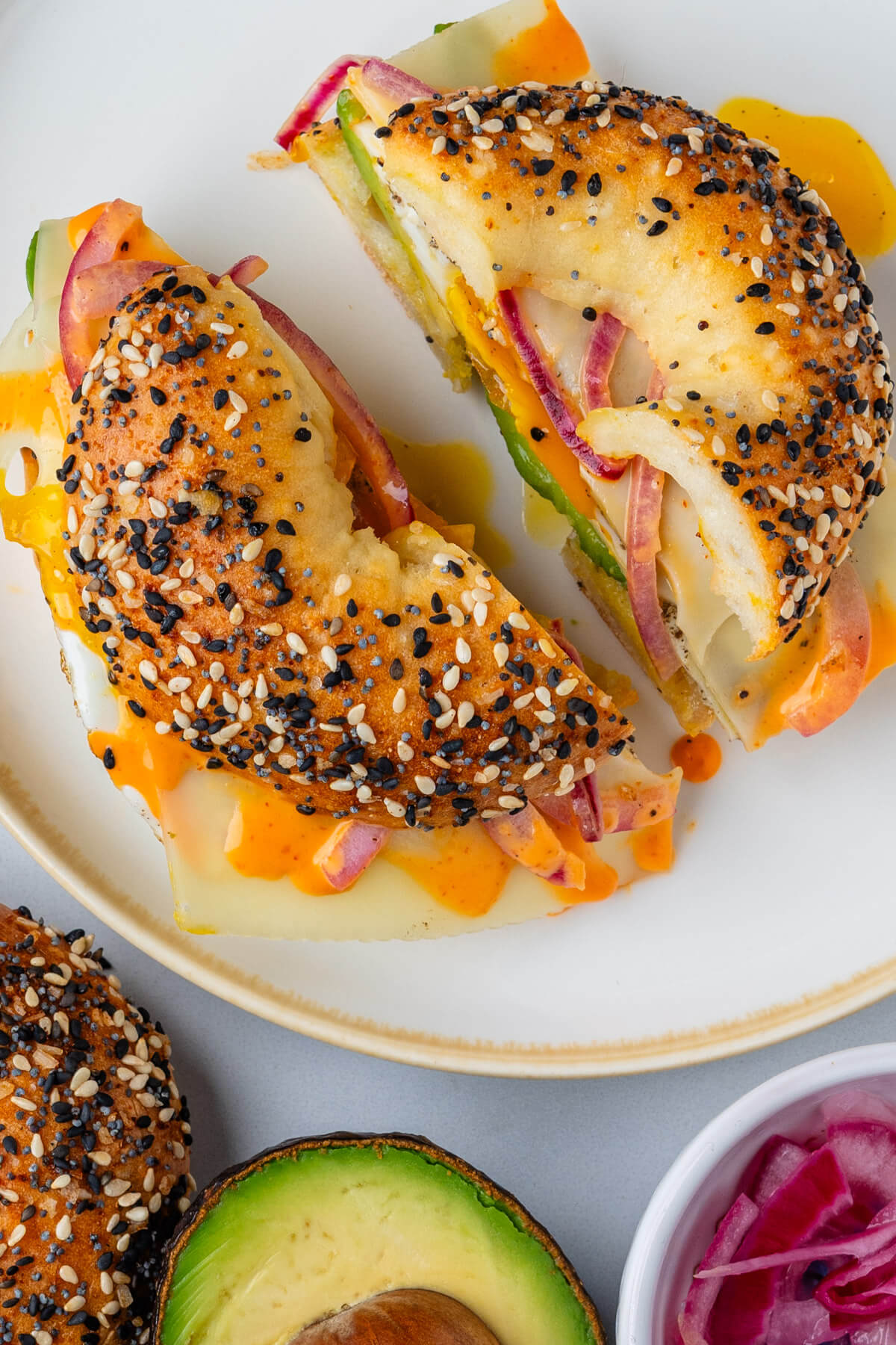 Breakfast bagel on a plate cut in half