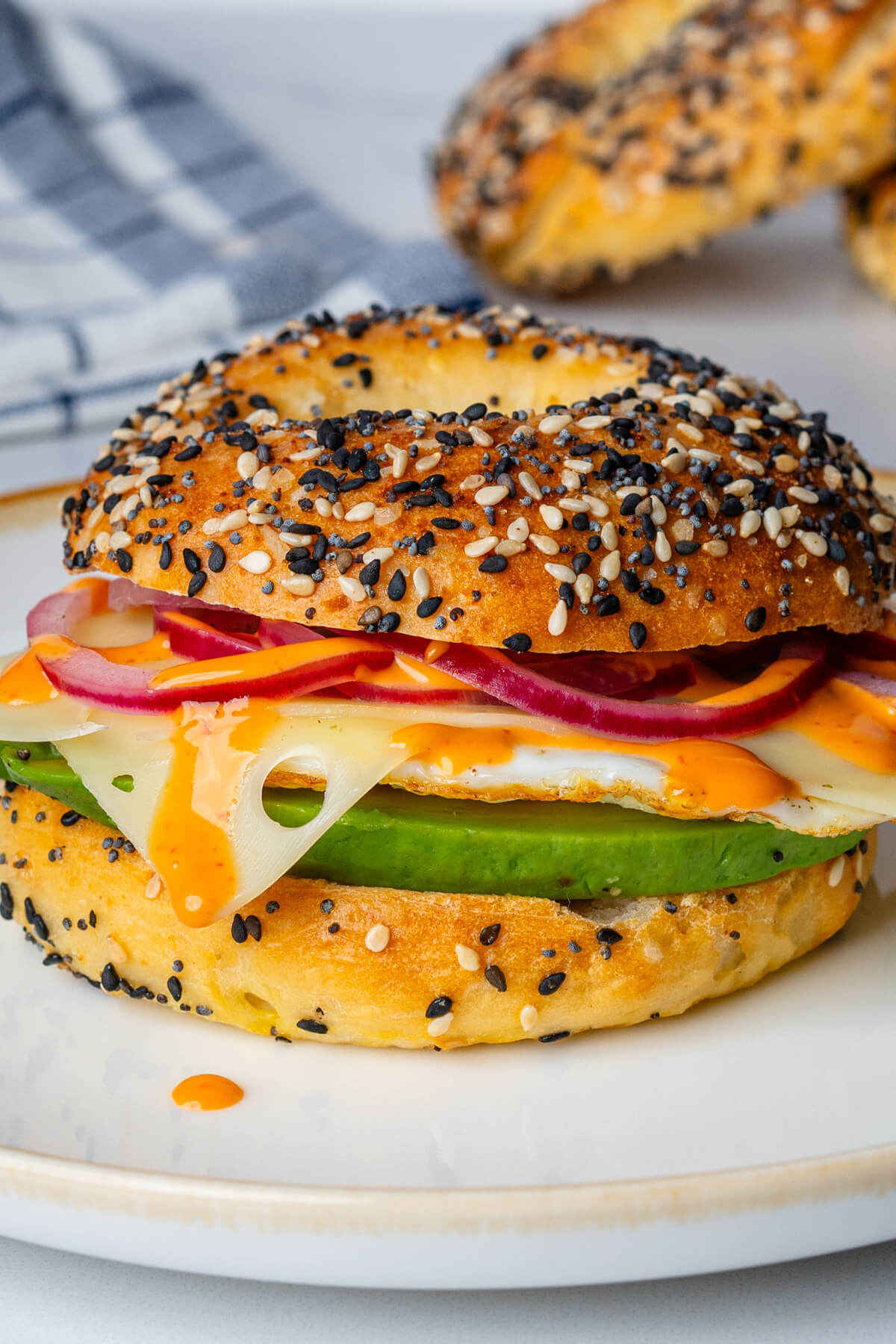 Breakfast bagels with egg, pickled onions, avocado and cheese