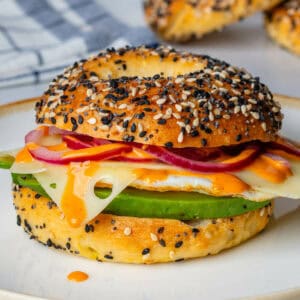 Breakfast bagels with egg, pickled onions, avocado and cheese