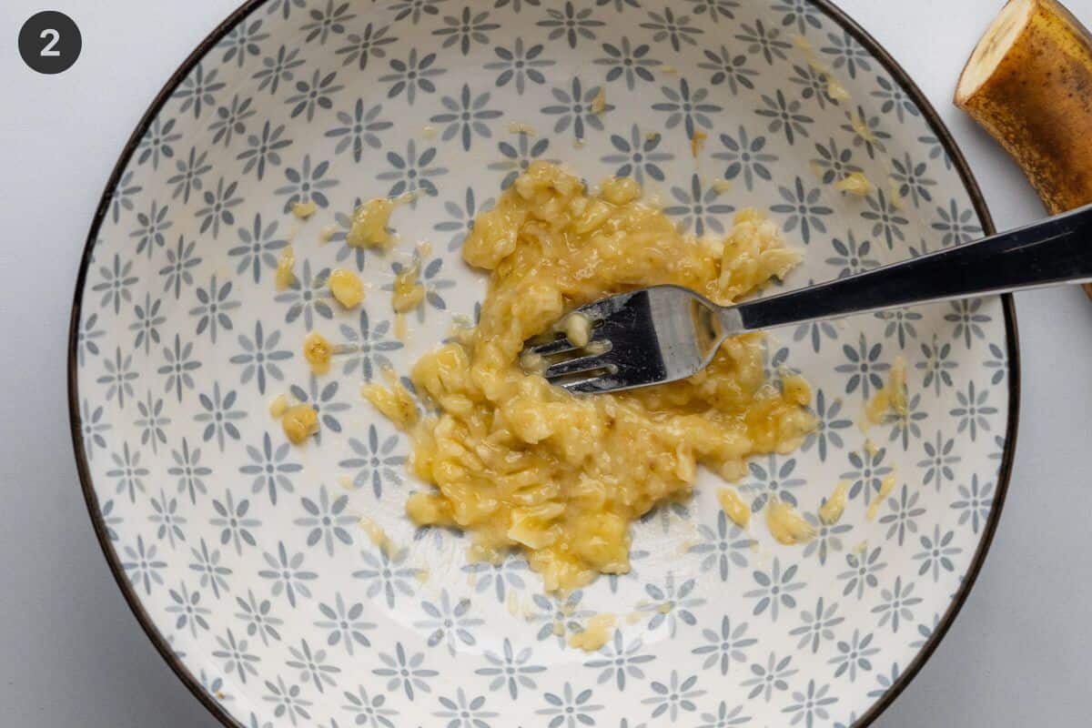 Half a banana mashed with a fork