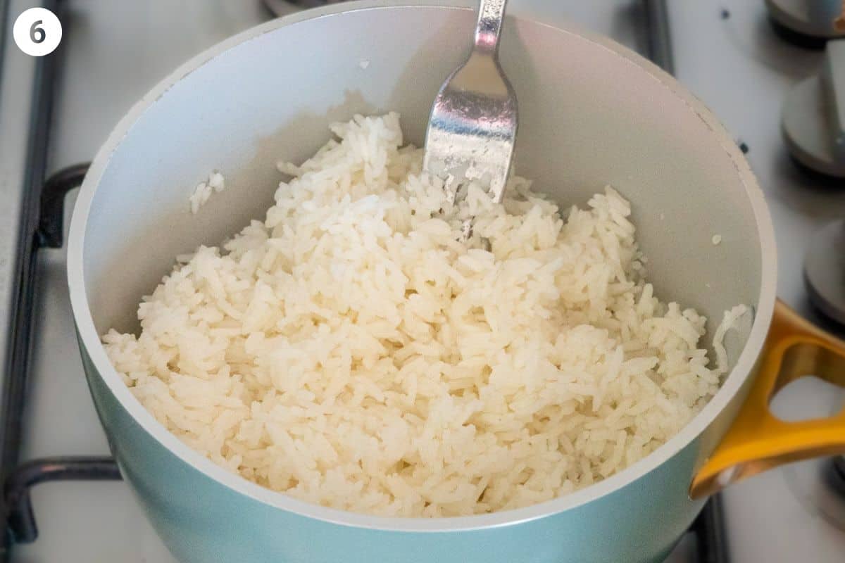 Fork gently fluffing jasmine rice