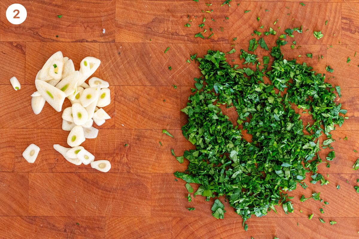 Garlic and parsley chopped on a cutting board