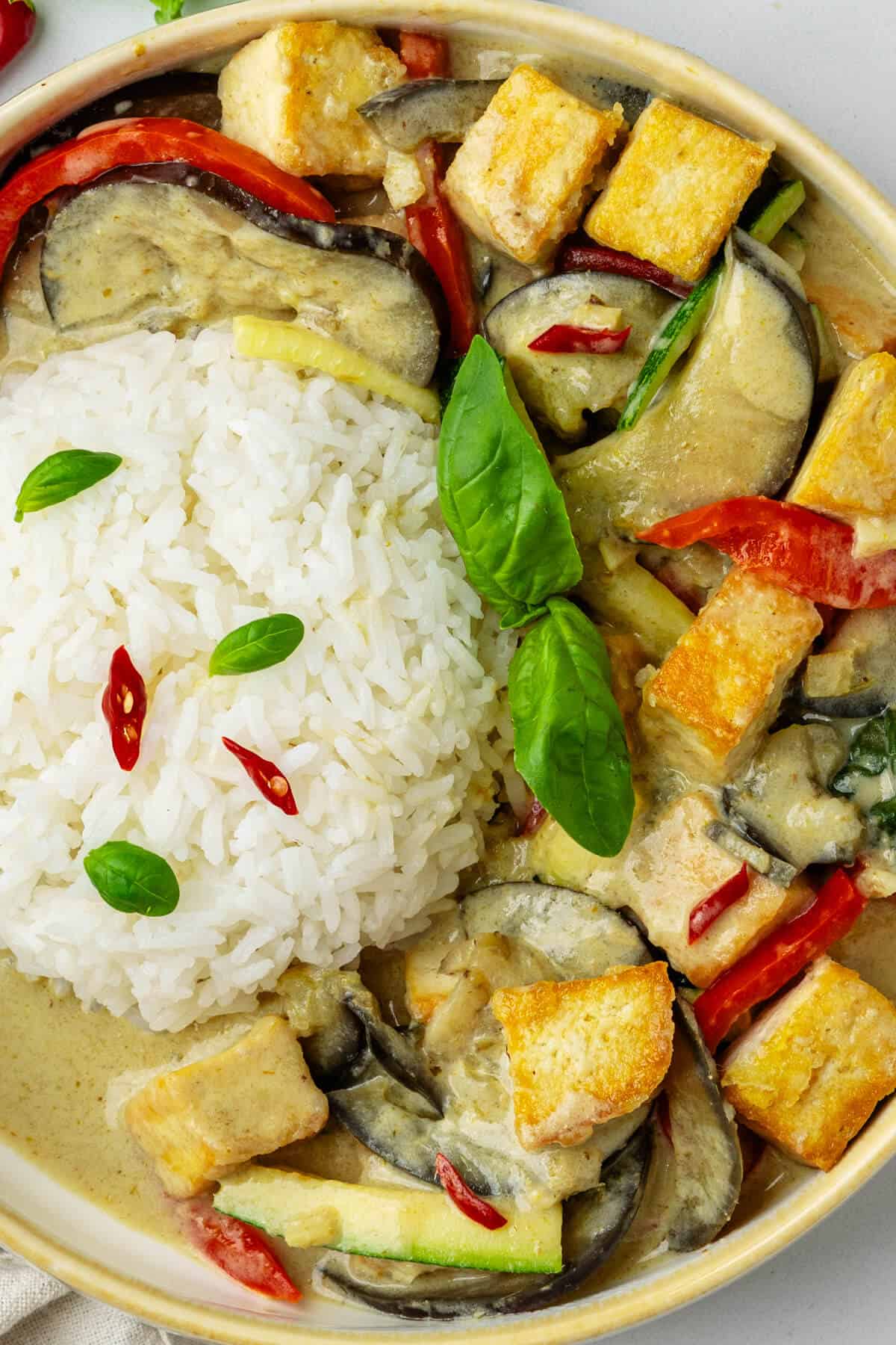 Bowl of thai green curry served with jasmine rice