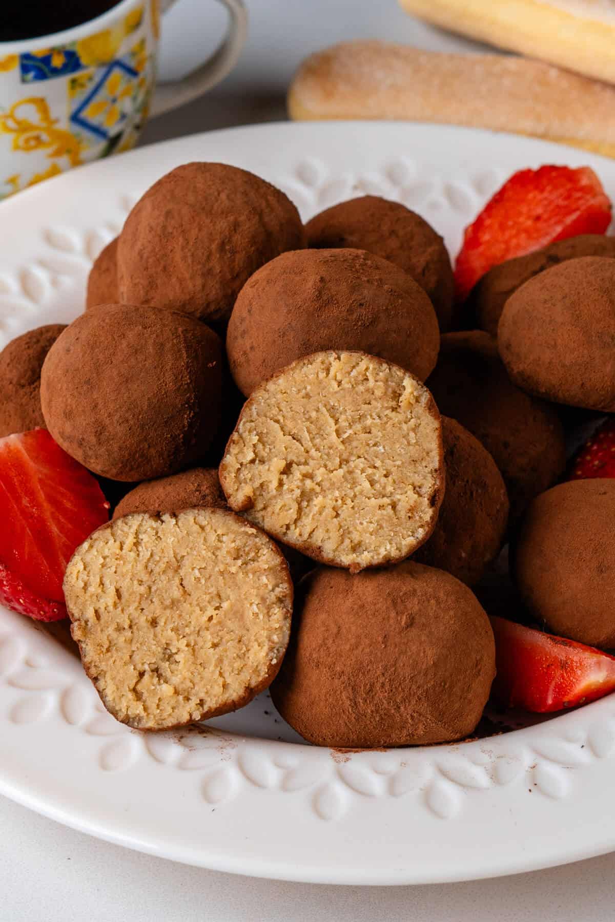 Tiramisu truffles with piece cut in half to show the inside