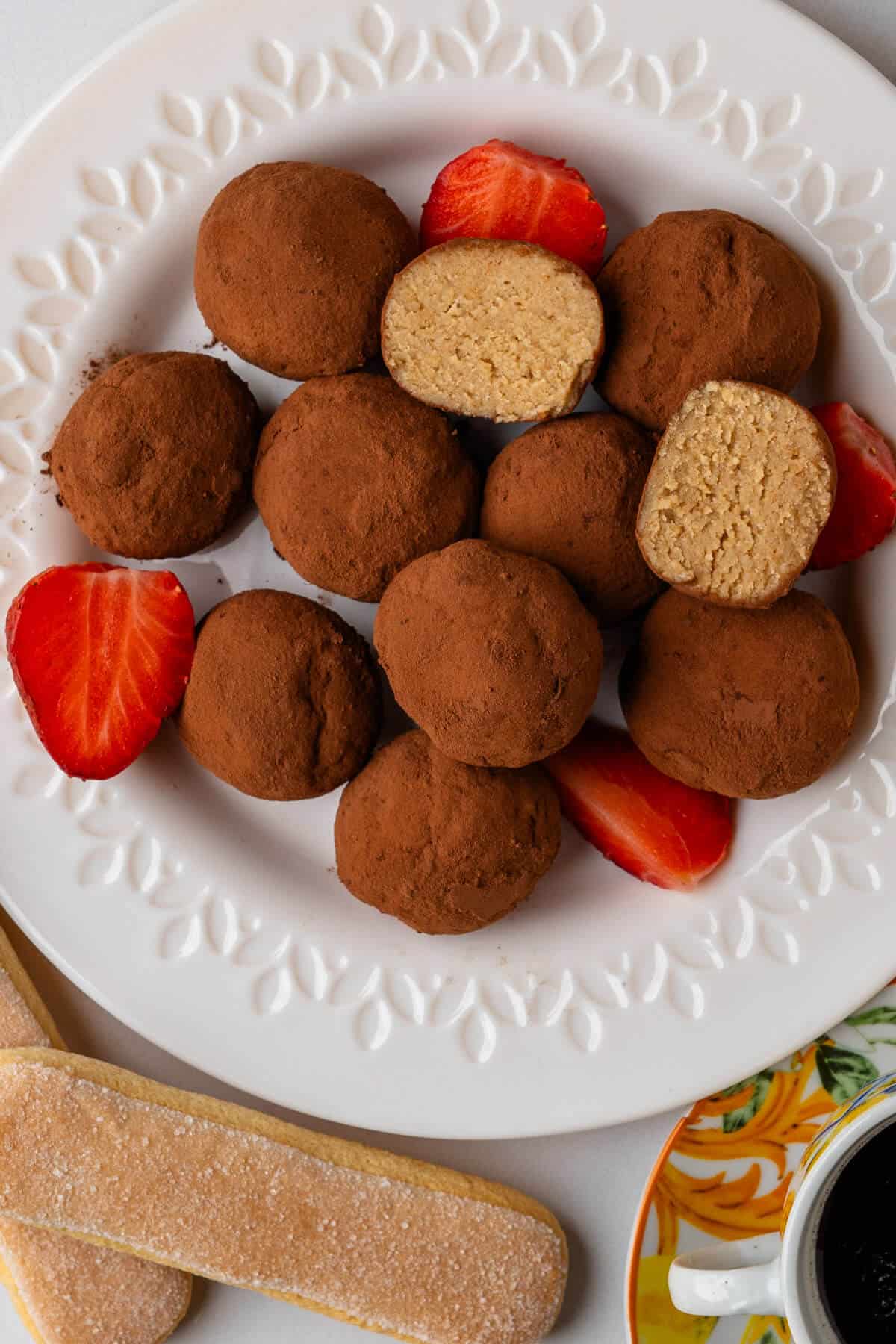 Plate of tiramisu truffles served with strawberries