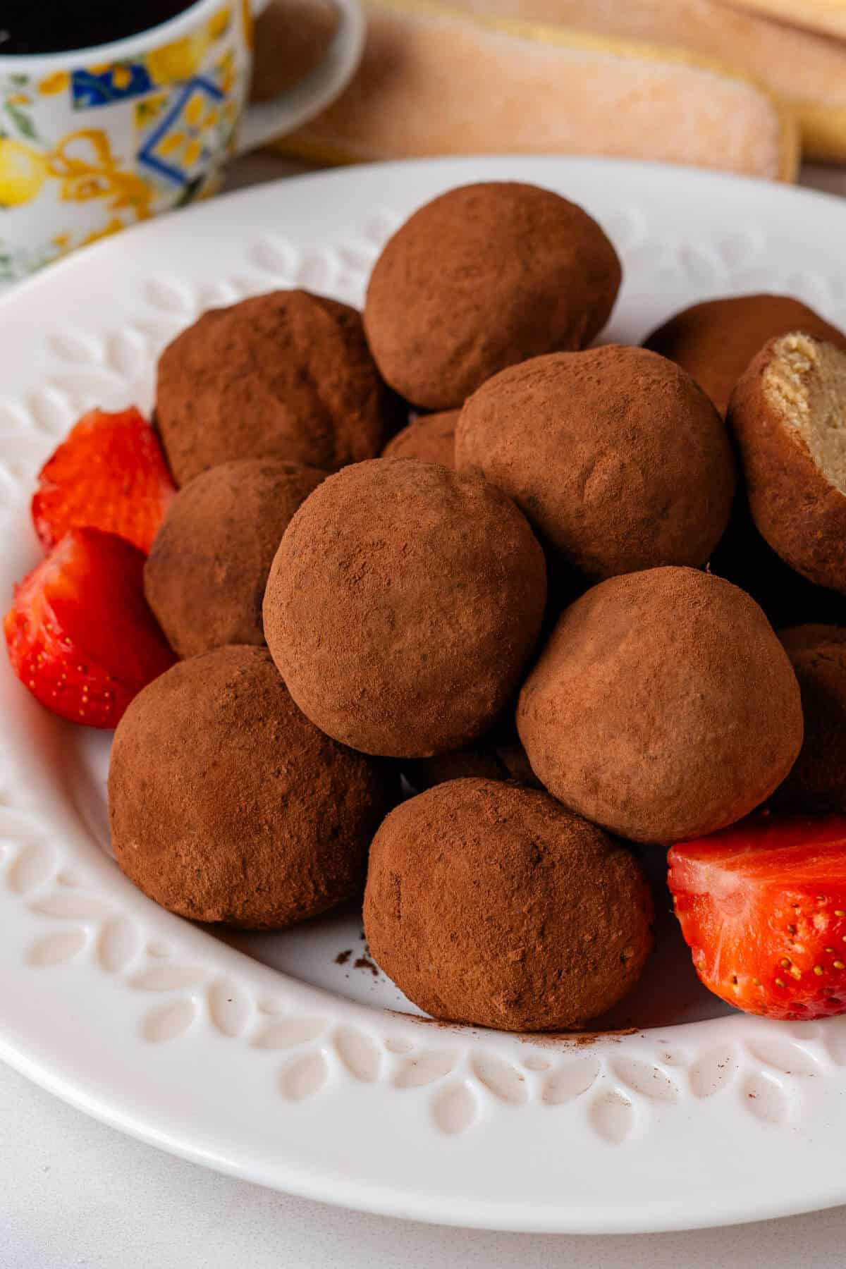 Tiramisu truffles on a plate with strawberries