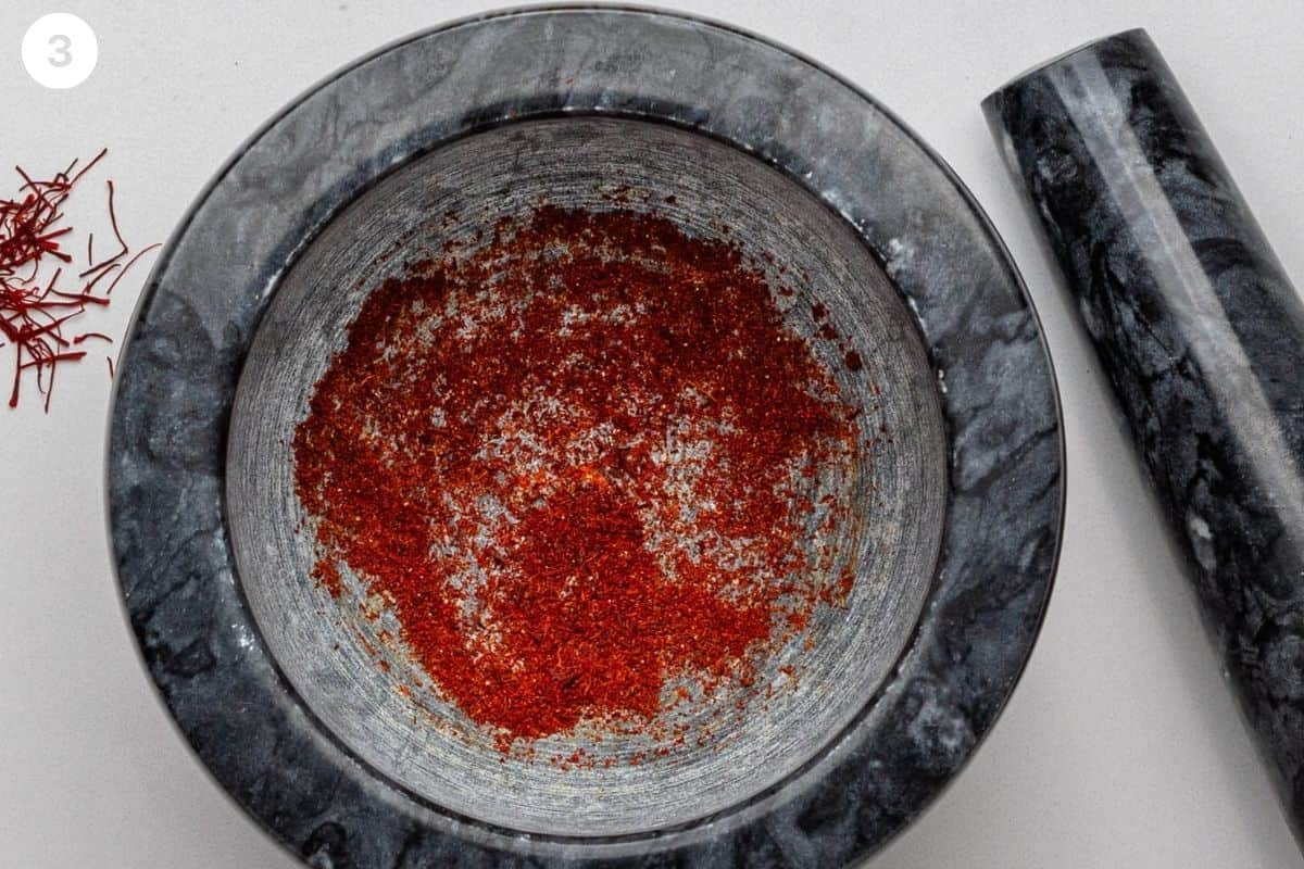 Saffron threads grinded with a mortar and pestle