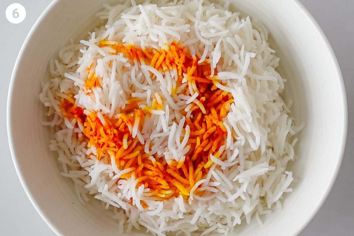 Infused saffron added to a portion of rice in a bowl