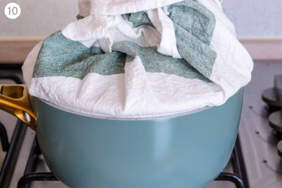 Lid wrapped with a tea towel placed on the pot