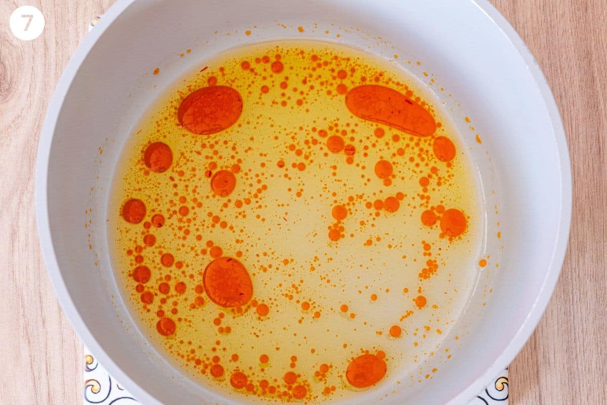 Oil and saffron water added to a pot