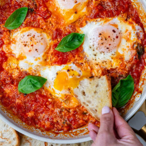 Bread being dipped into Eggs in Purgatory