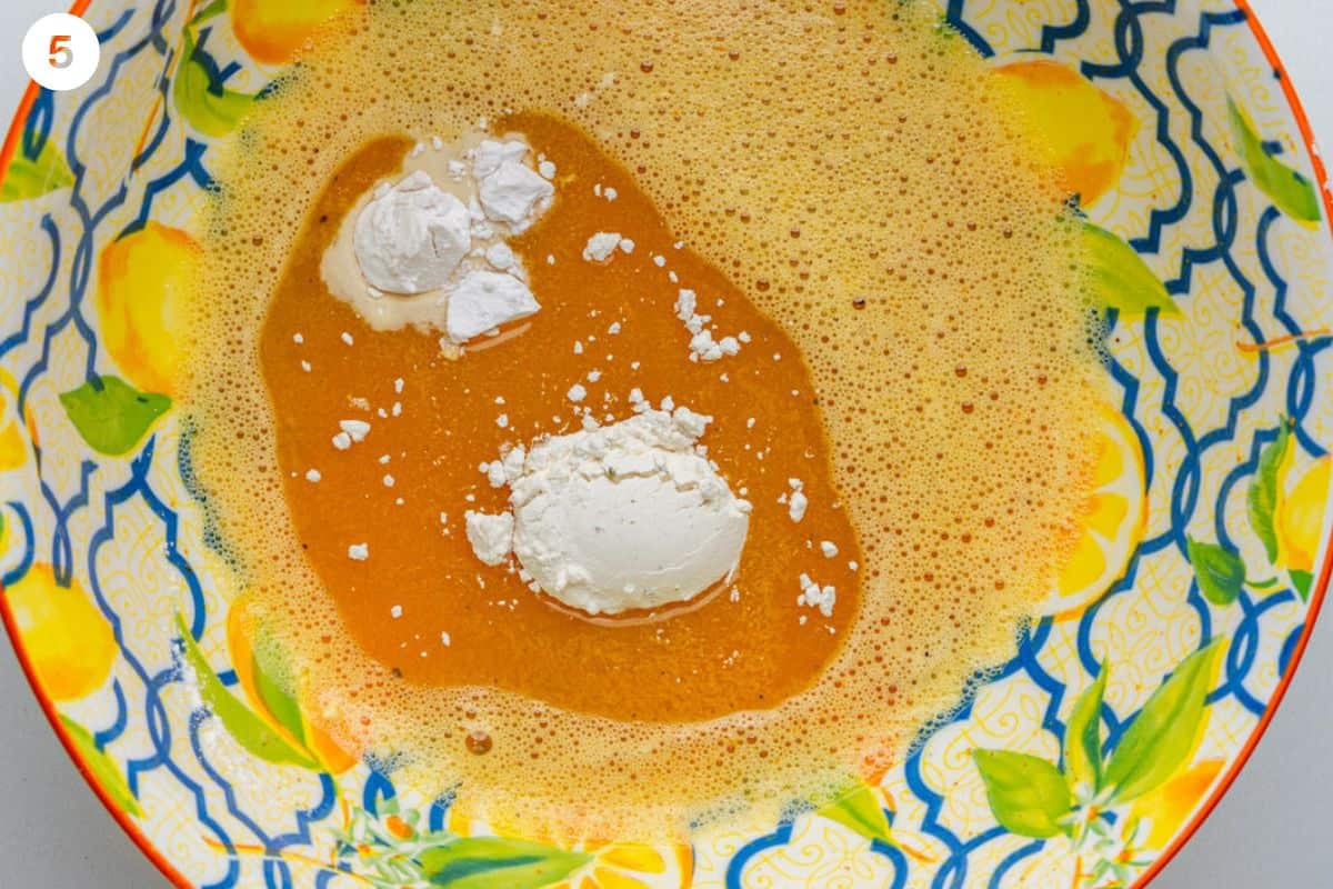 Eggs whisked with flour added to bowl