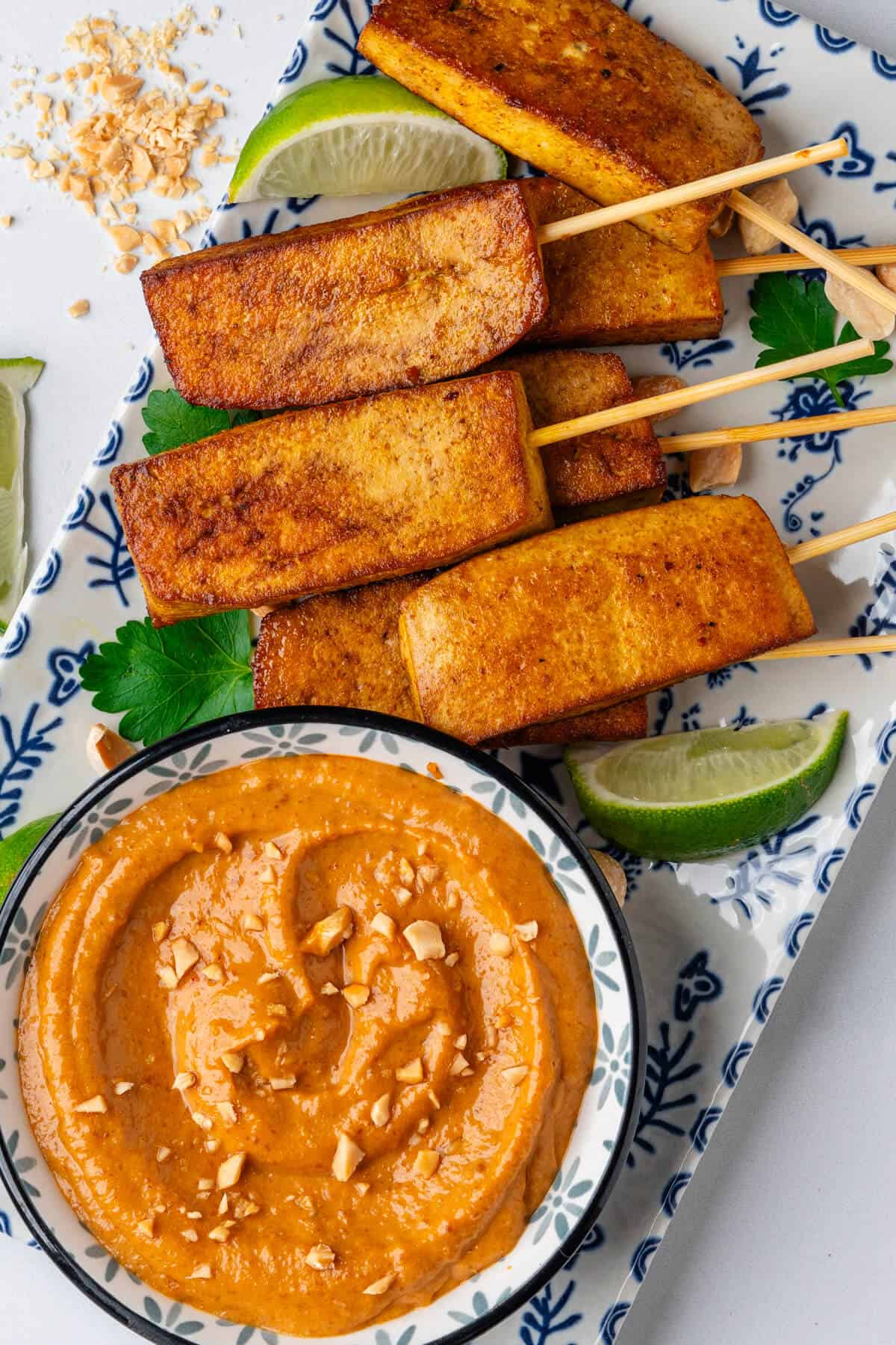 Thai peanut satay sauce on a platter with tofu satay