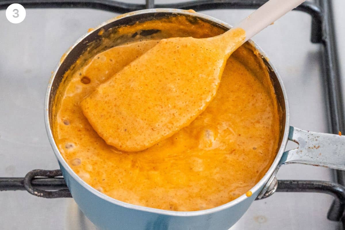 Spatula mixing sauce in a small pot