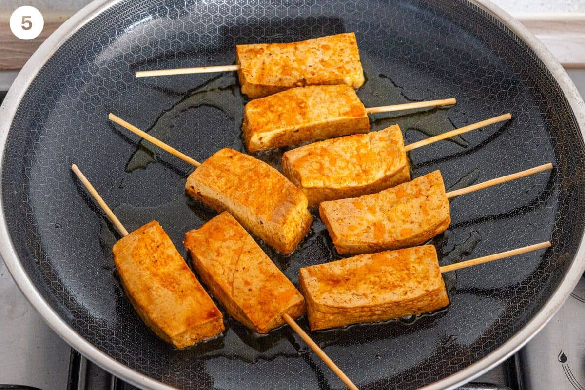 Tofu being cooked on a pan