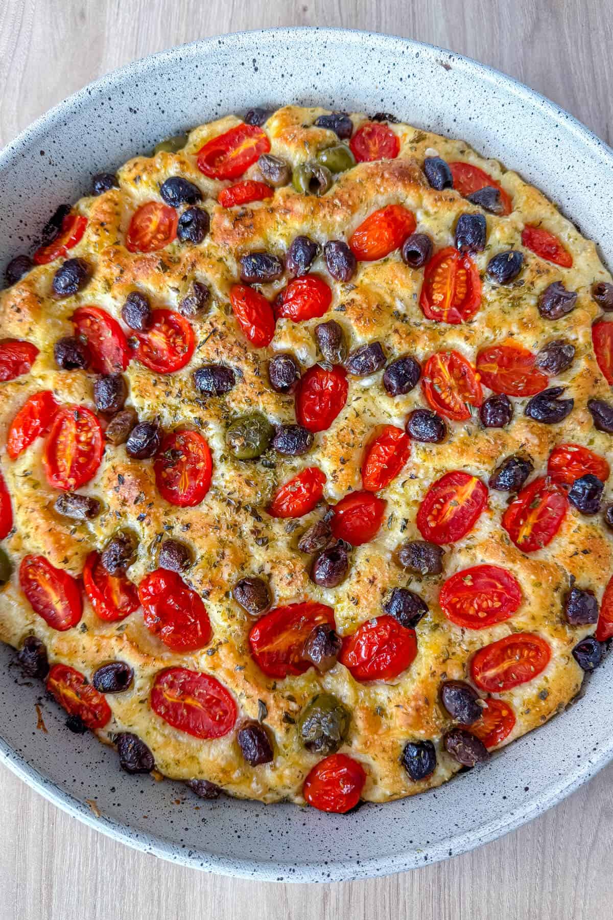 No knead focaccia with barese topping with olives, oregano and cherry tomatoes