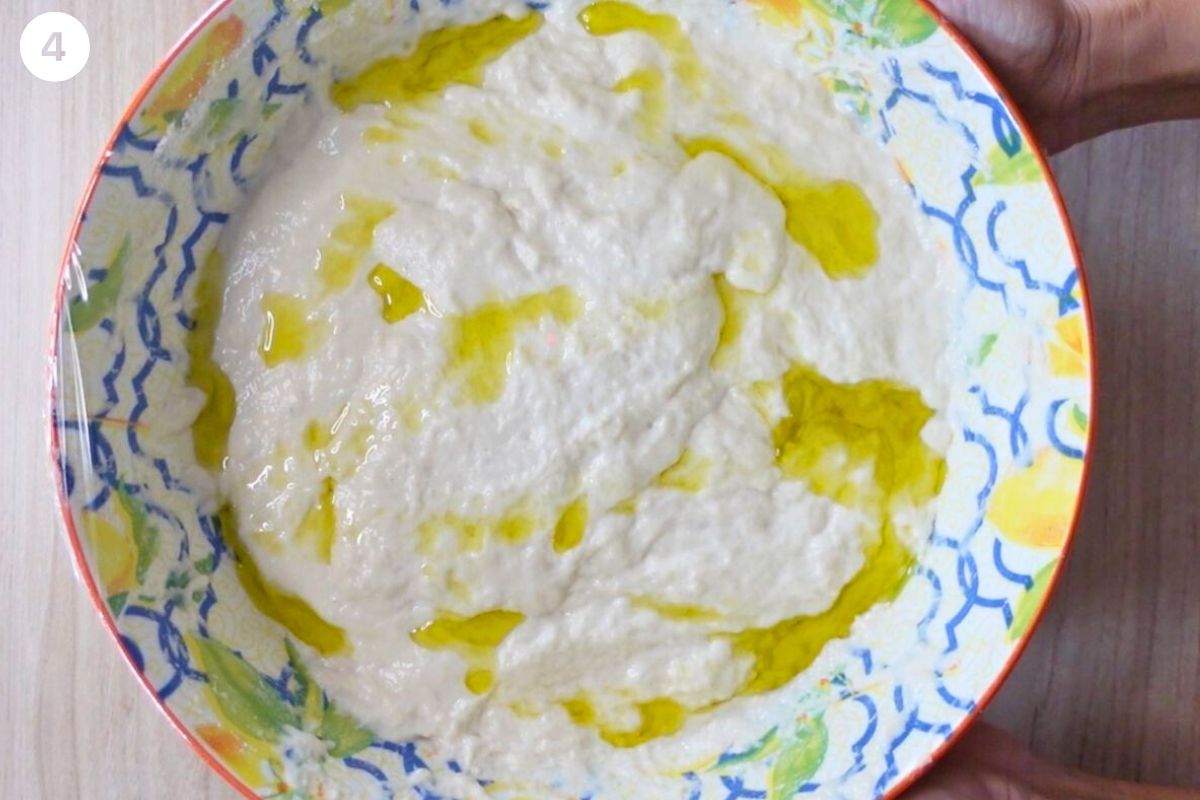 Olive oil drizzled on top and covered with cling wrap