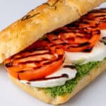 Caprese sandwich with mozzarella, pesto, tomato and balsamic glaze