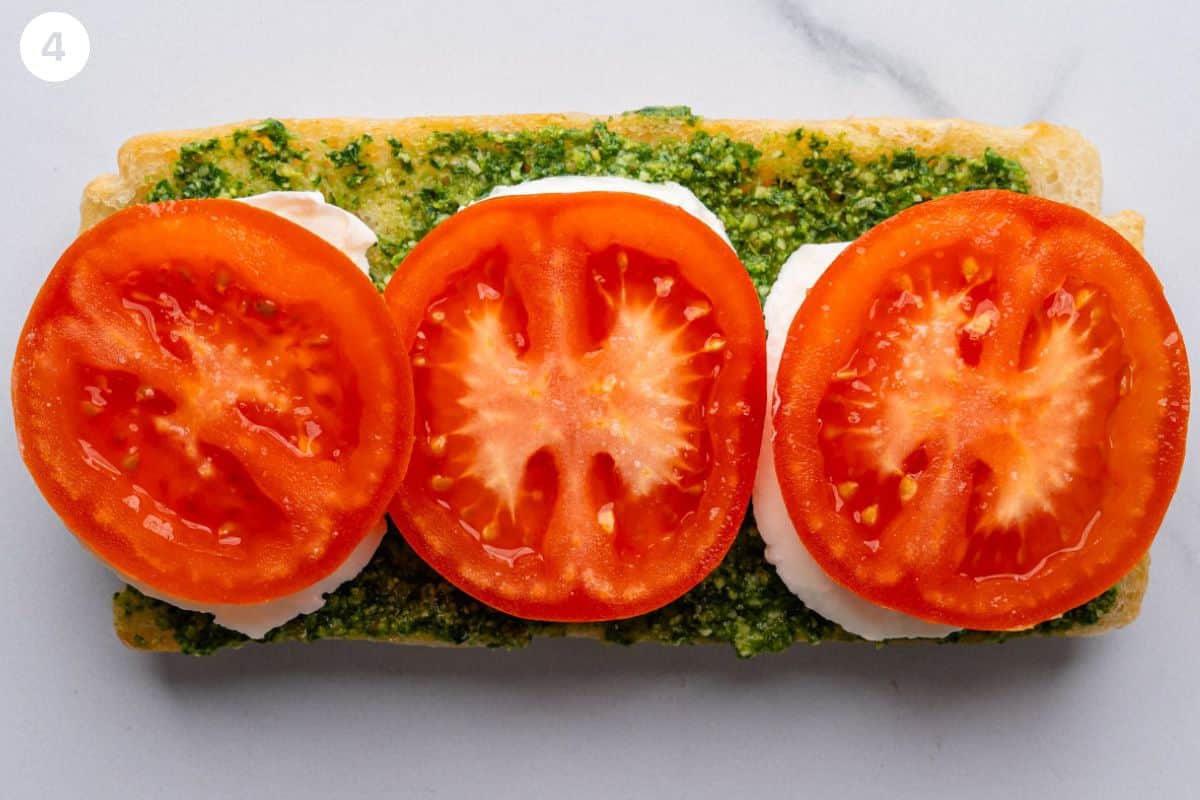 Mozzarella and tomato added on top of pesto