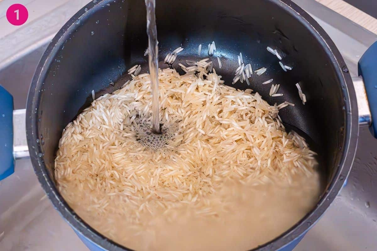 Washing rice in a large pot