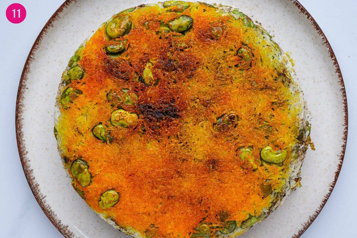 Baghali polo flipped upside down on a plate to have crispy tahdig